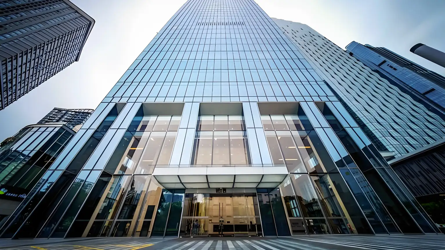 Fachada moderna de un rascacielos de cristal en una ciudad empresarial.