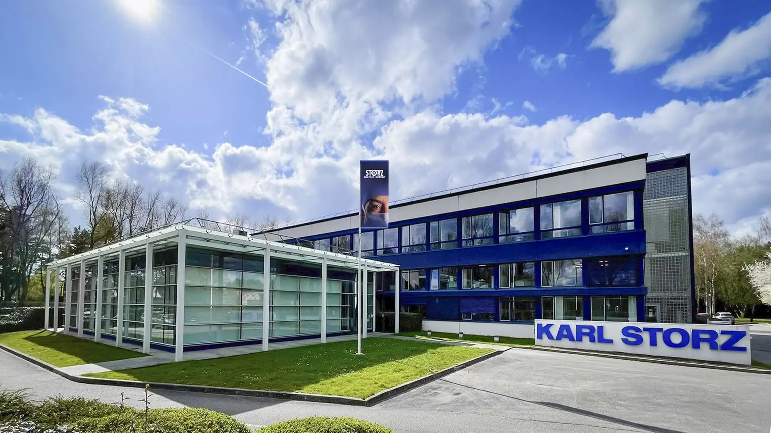 Здание компании Karl Storz с современной стеклянной архитектурой и большой вывеской у входа.