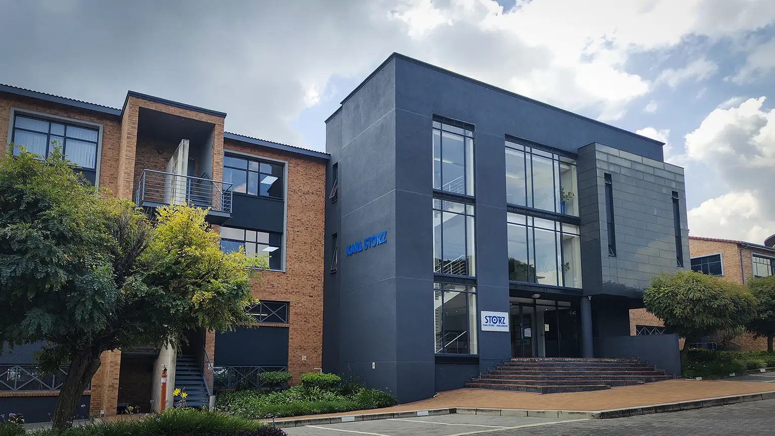 Modern office building with large glass windows and a sign reading KARL STORZ on the facade.