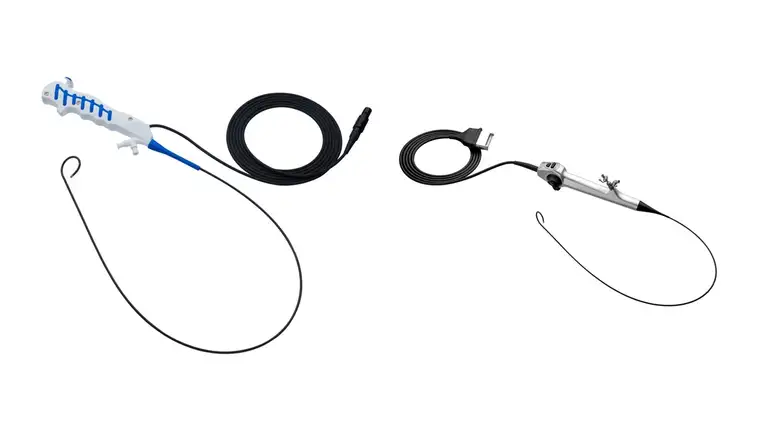 Two flexible endoscopic medical instruments with cables and ergonomic handles are displayed.