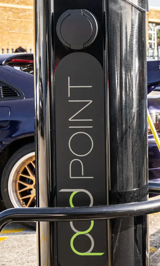 Pod Point electric vehicle charging station with charging socket visible.