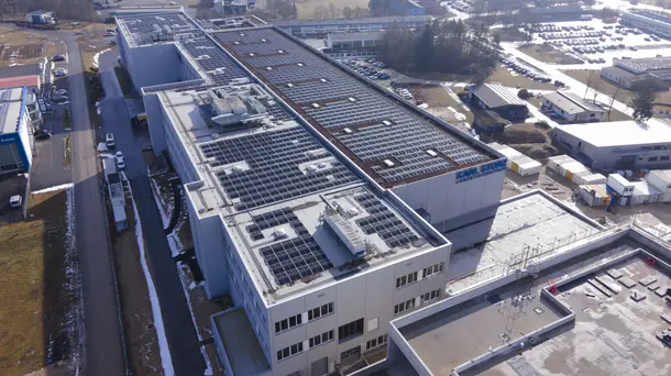 Large industrial building with solar panels installed on the roof.