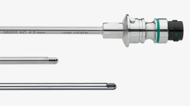 Close-up of a medical endoscope and surgical instruments for minimally invasive procedures.