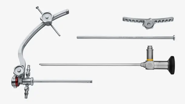 Set of surgical endoscopy instruments, including a clamp, rod, and endoscope, arranged on a white background.