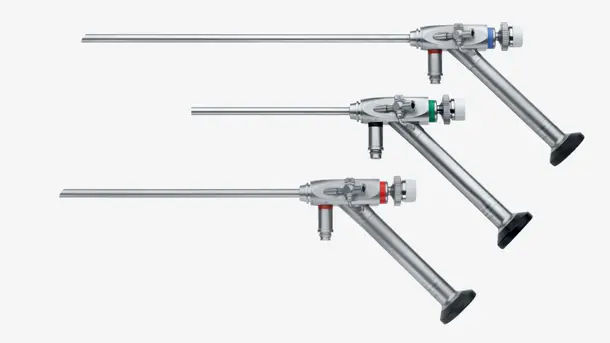 Three rigid medical endoscopes with angled eyepieces and colored bands are arranged side by side.