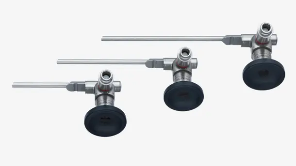 Three stainless steel rigid endoscopes with black eyepieces arranged side by side.