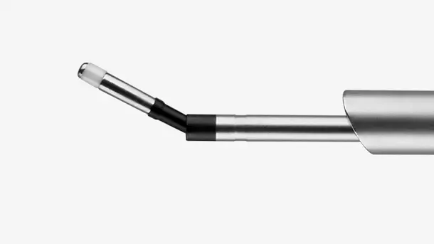 Close-up of a metal dental scaler tip used for professional teeth cleaning.