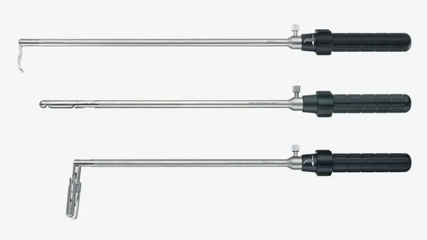 Three different types of surgical endoscopic instruments with long metal shafts and black handles.