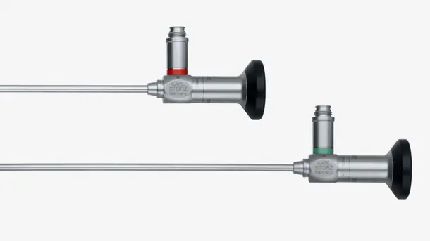 Two Karl Storz rigid endoscopes with metal shafts and eyepieces, positioned horizontally.