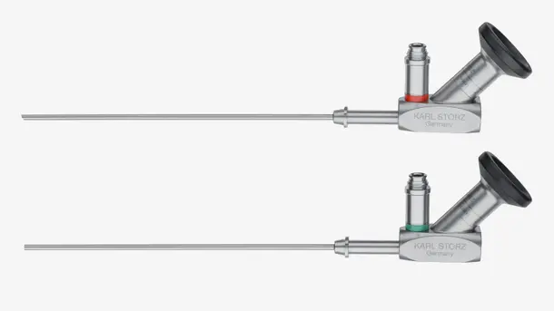 Two KARL STORZ stainless steel endoscopes with angled eyepieces for medical examinations.