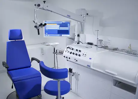 Modern ENT examination chair with advanced medical equipment and monitor in a clinical setting.