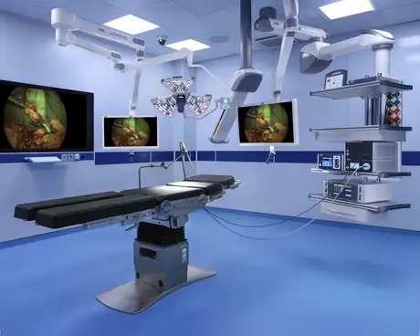 Modern operating room with surgical table, advanced equipment, and medical monitors.