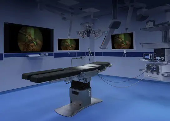 Modern operating table with surgical monitors displaying a minimally invasive procedure.