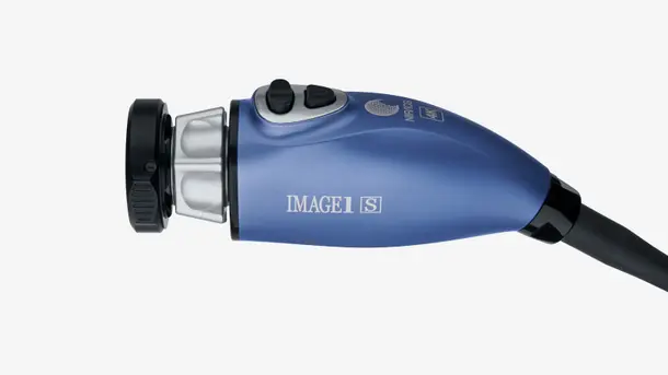 Blue medical camera head with IMAGE1 S branding and two control buttons.