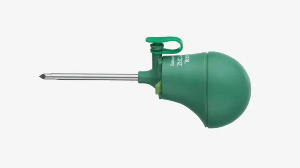Green-handled surgical trocar with a pointed metal tip and ergonomic grip.