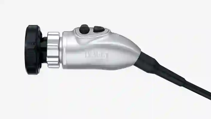 Medical endoscope camera head with control buttons and cable connection.