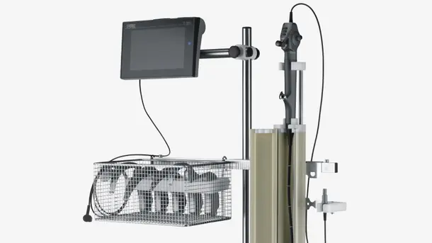 Medical endoscopy equipment with a monitor, control handle, and storage basket.