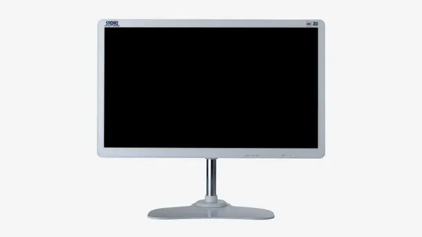Front view of a 4K 3D medical monitor with a black screen on a stand.