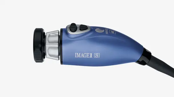 Close-up of a blue medical endoscopic camera head with control buttons.