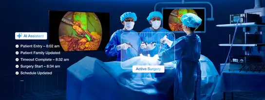 Surgeons performing laparoscopic surgery with AI assistant and real-time medical imaging displayed on monitors.