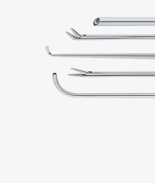 Close-up of four stainless steel surgical instruments arranged horizontally.