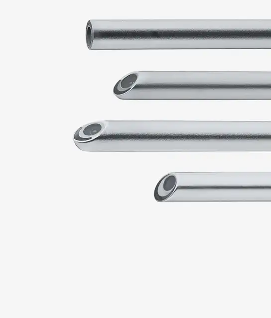 Four stainless steel tubes with varying angled bevel tips displayed horizontally.