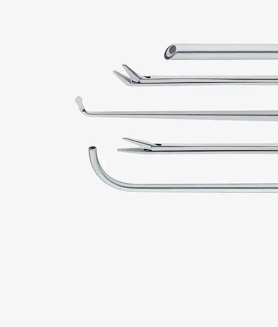 Four different surgical instruments arranged horizontally, showing various tips and shapes.