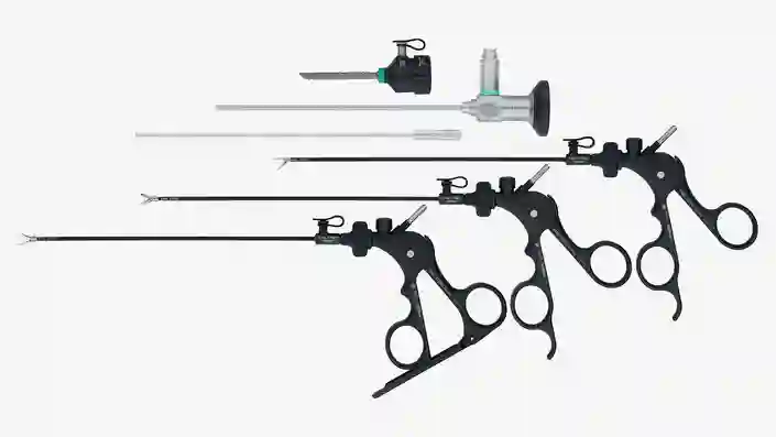Set of black laparoscopic surgical instruments with ergonomic handles displayed on a white background.